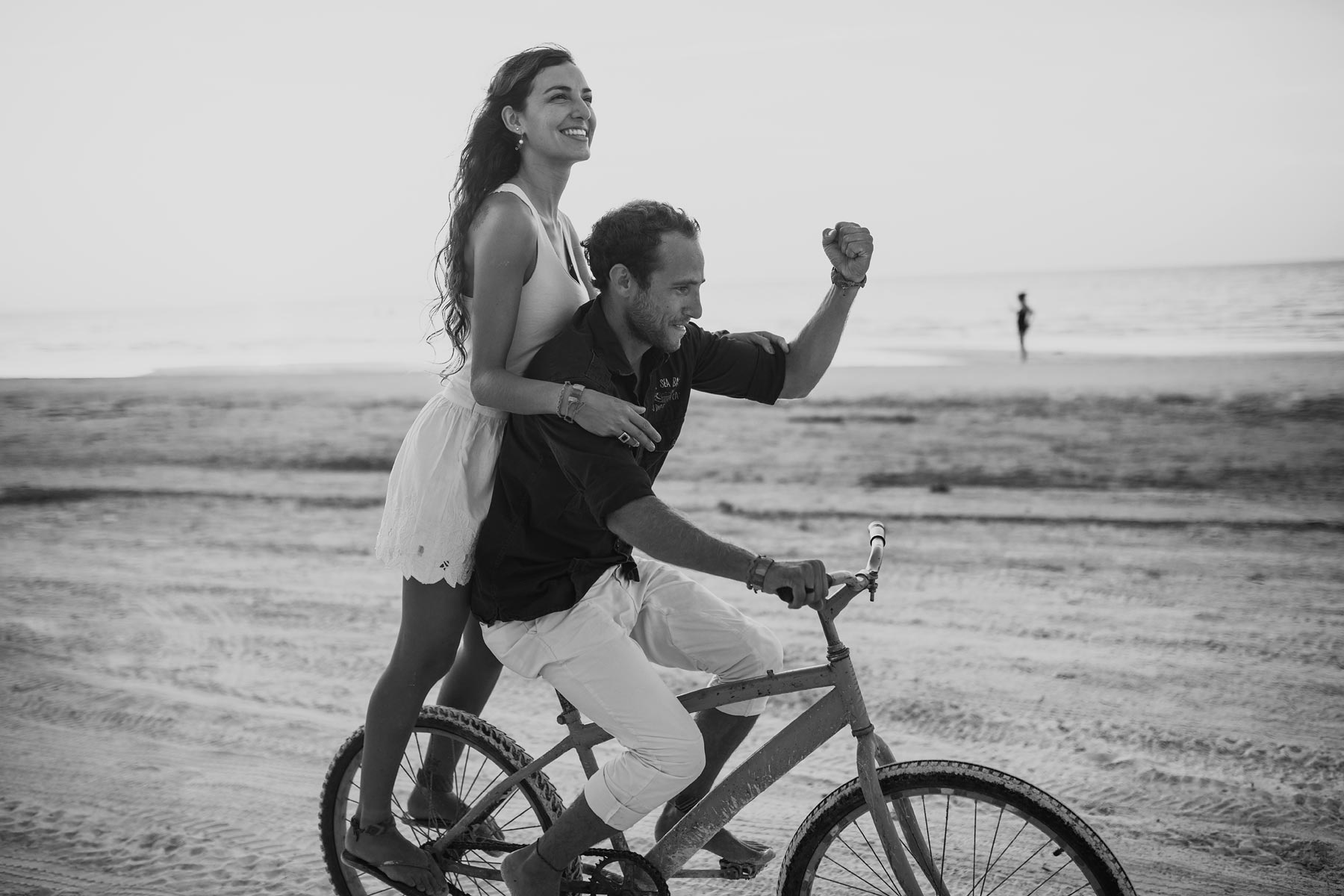 couple riding bike in holbox